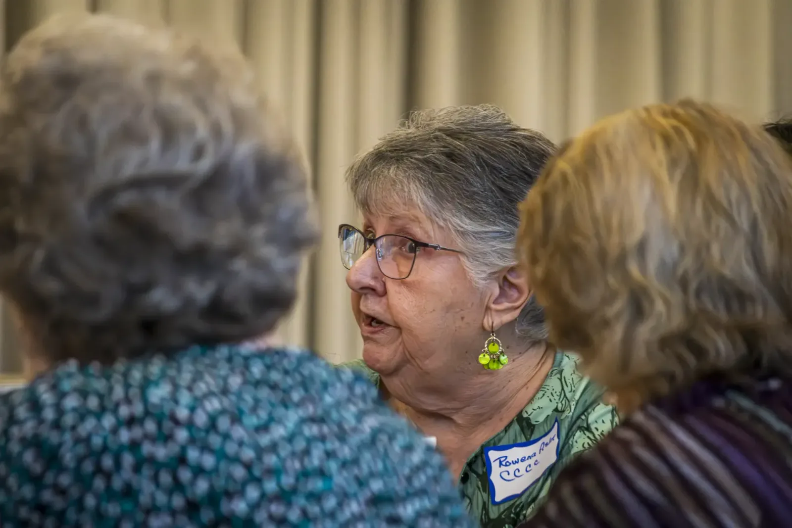 A Community Connectors participant speaks with neighbors in a listening circle.